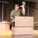 Photos by Laura Guido/Whidbey News-Times                                Ben Huneycutt, playing stick-in-the-mud Capt. Frank Burns pulls a dead cat from his trunk. No real cats were harmed in the production of this play.