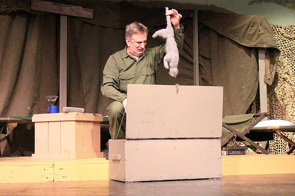 Photos by Laura Guido/Whidbey News-Times                                Ben Huneycutt, playing stick-in-the-mud Capt. Frank Burns pulls a dead cat from his trunk. No real cats were harmed in the production of this play.