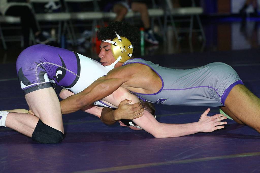 Jamal Graham, right, takes control of Anacortes Gavin Lang.(Photo by John Fisken)
