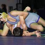 Oak Harbors Cole Valdez, top, works to turn Anacortes Ayden Swain.(Photo by John Fisken)