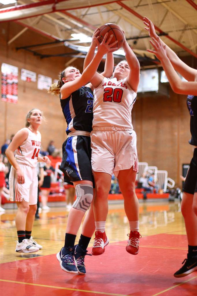 Avalon Renninger (20) battles South Whidbeys Ella Wood for a rebound.(Photo by John Fisken)