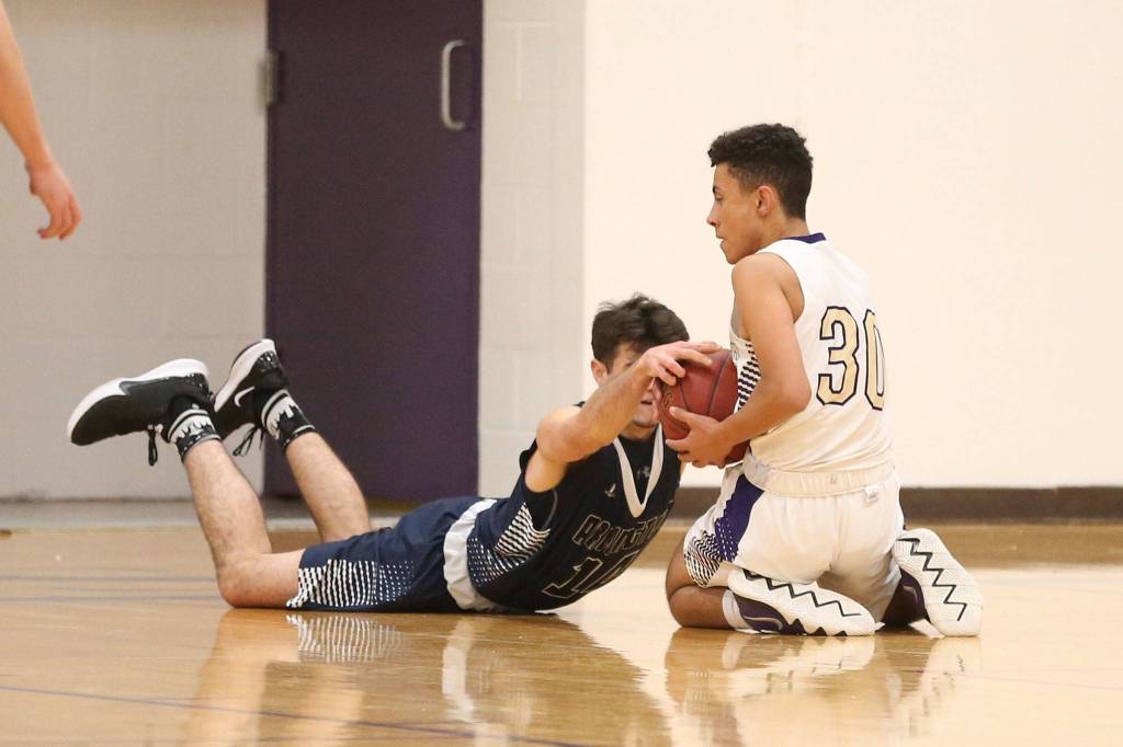 Senior Josh Pendleton, right, fights for possession with Arlingtons Ryan Brown.(Photo by John Fisken)