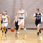 Couievilles Savina Wells (5) leads a fast break while Desi Ramirez fills a lane.(Photo by John Fisken)