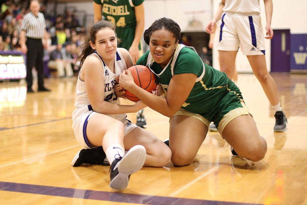 Oak Harbors Grace Waite, left, battles for possession.(Photo by John Fisken)
