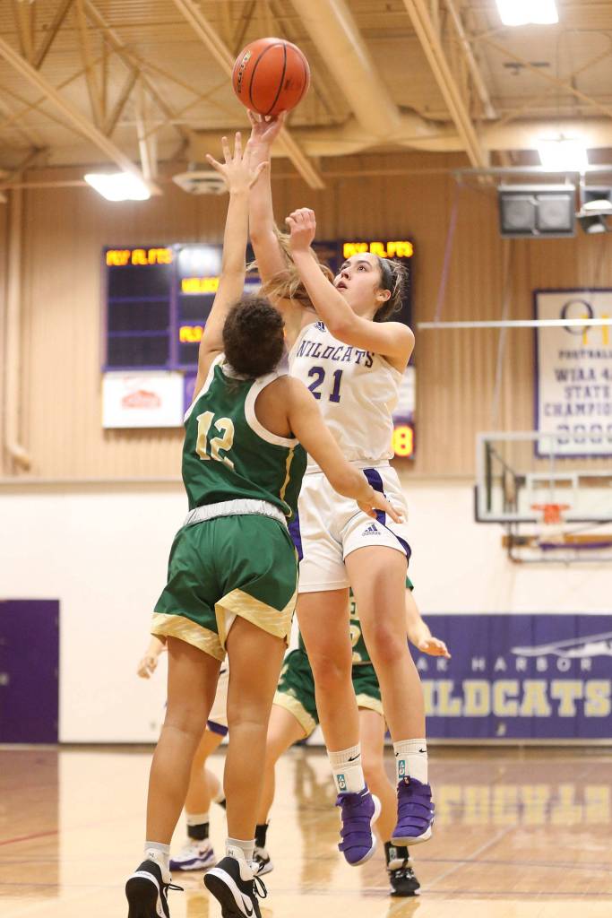 Oak Harbors Mikhaela Cortez shoots over the defense of Marysville Getchells Ellie Jackson. (Photo by John Fisken)