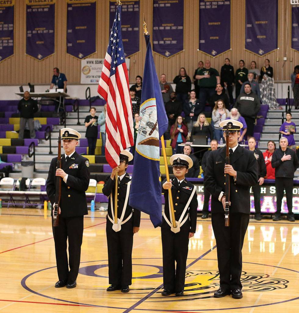 The OHHS color guard  Andrew Dixon, left, Trina Desquitado, Skye Kawi and Salvador Tirado) presents the flag before the game.(Photo by John Fisken)
