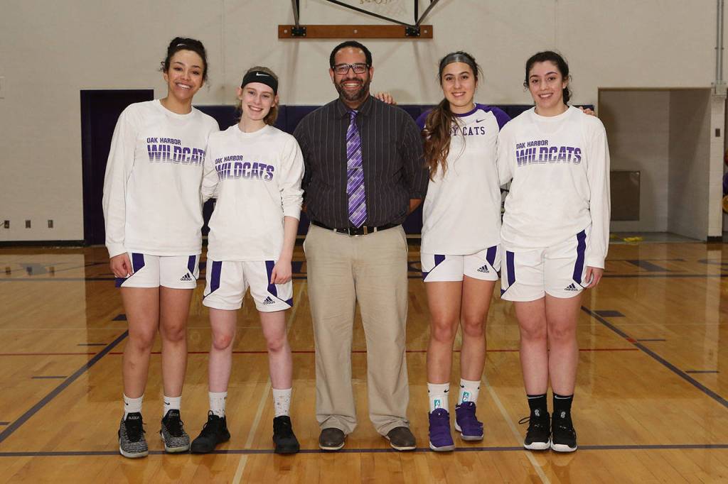 Oak Harbor seniors Jasmine Ford, left, Olivia Waite, Mikhaela Cortez and Anna Jones played their final game for coach Jon Atkins, center, Friday.