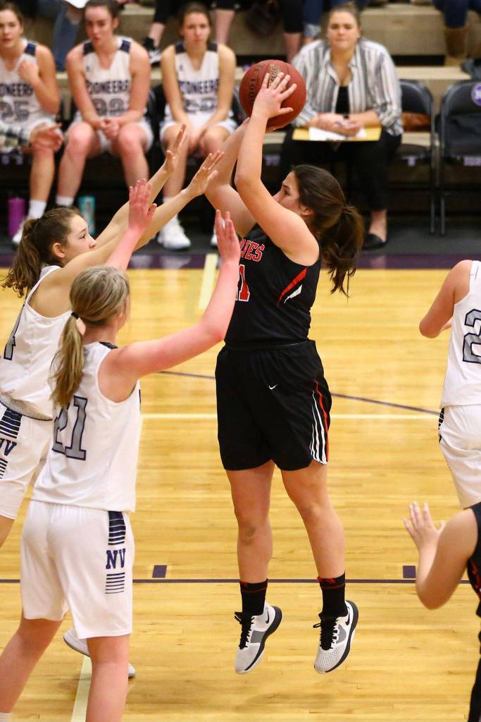 Carolyn Lhamon shoots over the Nooksack Valley defense. (Photo by John Fisken)