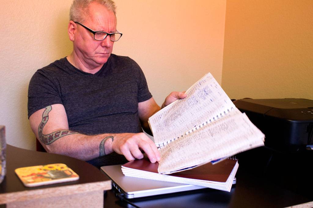 Photo by Brandon Taylor/Whidbey News-Times Daniel Edward Moore holds a log of all of the literary journals he has contacted. He said he gets about 13 rejections a day.