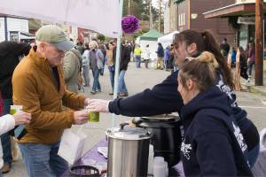 Photo by Brandon Taylor/Whidbey News-Times                                Denny DeWispelaere from Oak Harbor receives a tasting of Freeland Caffes Manhattan style chowder from Jill Bassett and Miranda Baugh.