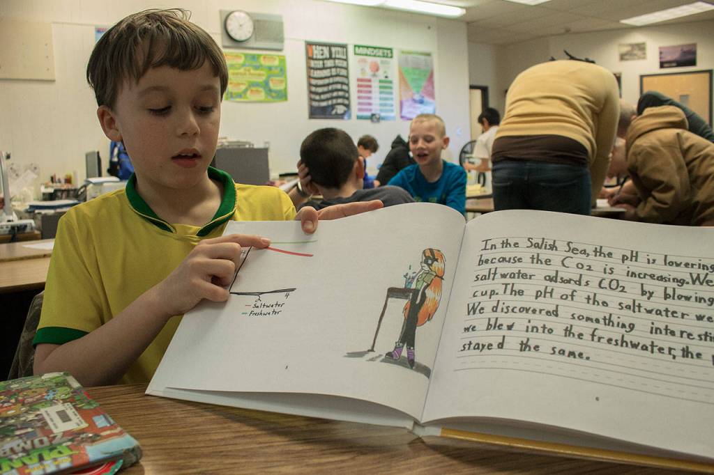 Photo by Brandon Taylor/Whidbey News-Times                                David Scheer, 9, points to a graph depicting the change in saltwater acidification based on an experiment the class conducted.