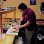 Photo by Brandon Taylor/Whidbey News Group                                Daniel Tarango makes a pulled rib sandwich in the BBQ Joint on Midway Boulevard in Oak Harbor.