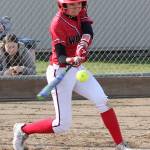 Scout Smith rips a base hit for the Coupeville High School softball team. (Photo by John Fisken)