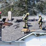 Photo by John Fisken                                Firefighters cut open the roof of a North Whidbey home to extinguish a fire in a concealed space.