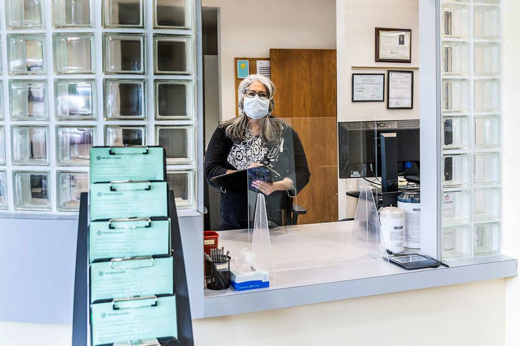 Photo provided                                Maria Reyes, manager of Patient Access Services for the new Clinton walk-in clinic, looks over last minute details before welcoming patients at the office, scheduled to open on Tuesday, June 2.