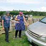 Photos by Kira Erickson/Whidbey News-Times                                Donna DeBonis, middle, her son, Daniel Cadwell, and daughter Diana Cadwell, stand in the spot where they saw Angela Kurtz emerging from the trailer on fire.