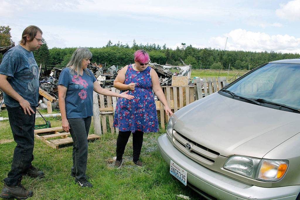 Photos by Kira Erickson/Whidbey News-Times                                Donna DeBonis, middle, her son, Daniel Cadwell, and daughter Diana Cadwell, stand in the spot where they saw Angela Kurtz emerging from the trailer on fire.