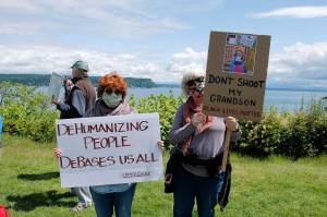 Photo by Kira Erickson/Whidbey News Group                                Clinton resident Claudia Fuller, right, and Freeland resident Rebecca Rickabaugh. Fuller holds a sign with a picture of her three-year-old grandson Elijah that says Dont shoot my grandson. Black Lives Matter.
