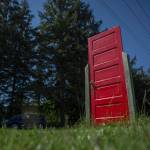 Photo by Olivia Vanni / The Herald                                A red door stands alone in a field along Cultus Bay Road in Clinton on South Whidbey.