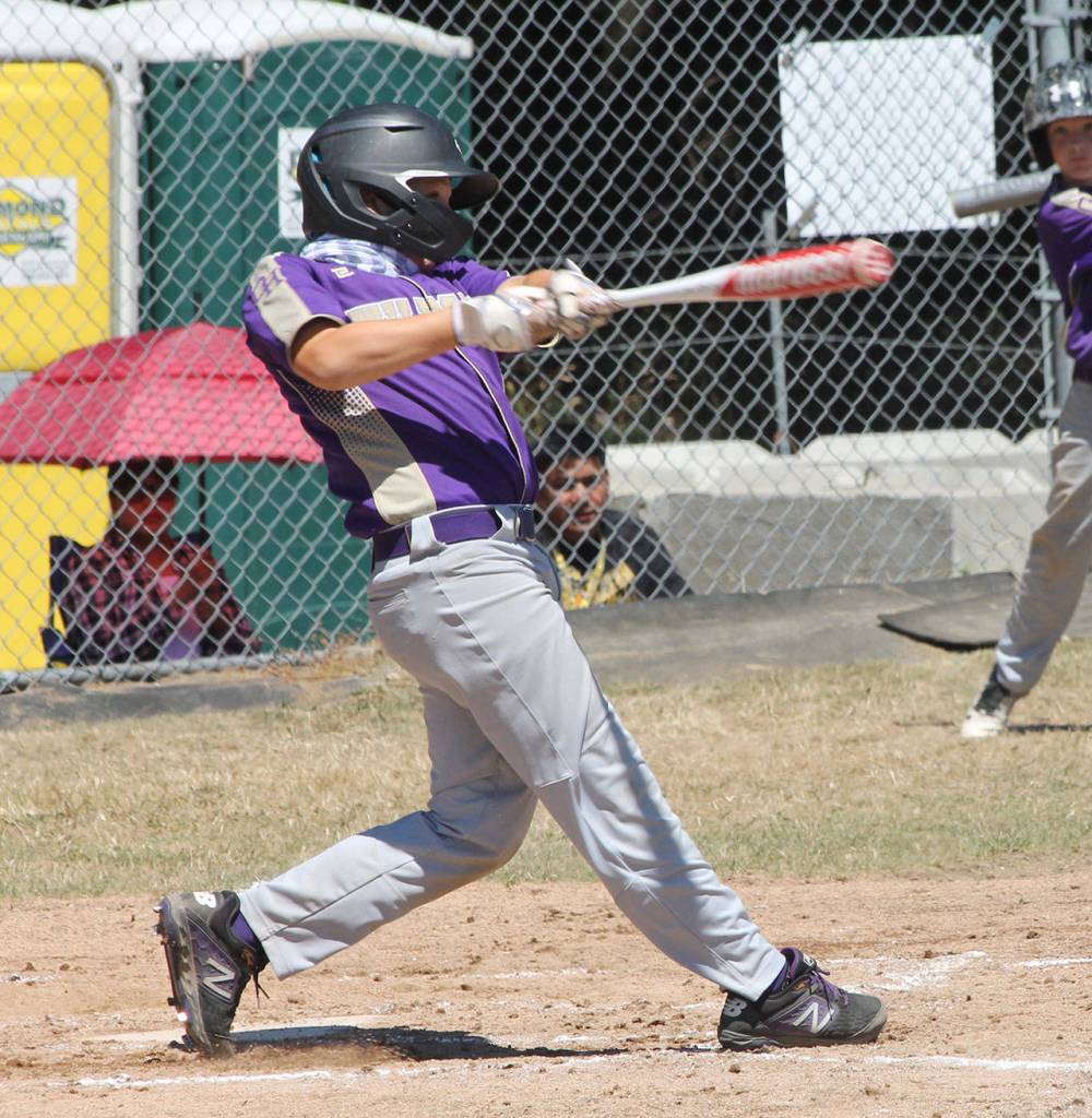 Christian Gisvold slashes a base hit for Oak Harbor. (Photo by Jim Waller/Whidbey News-Times)