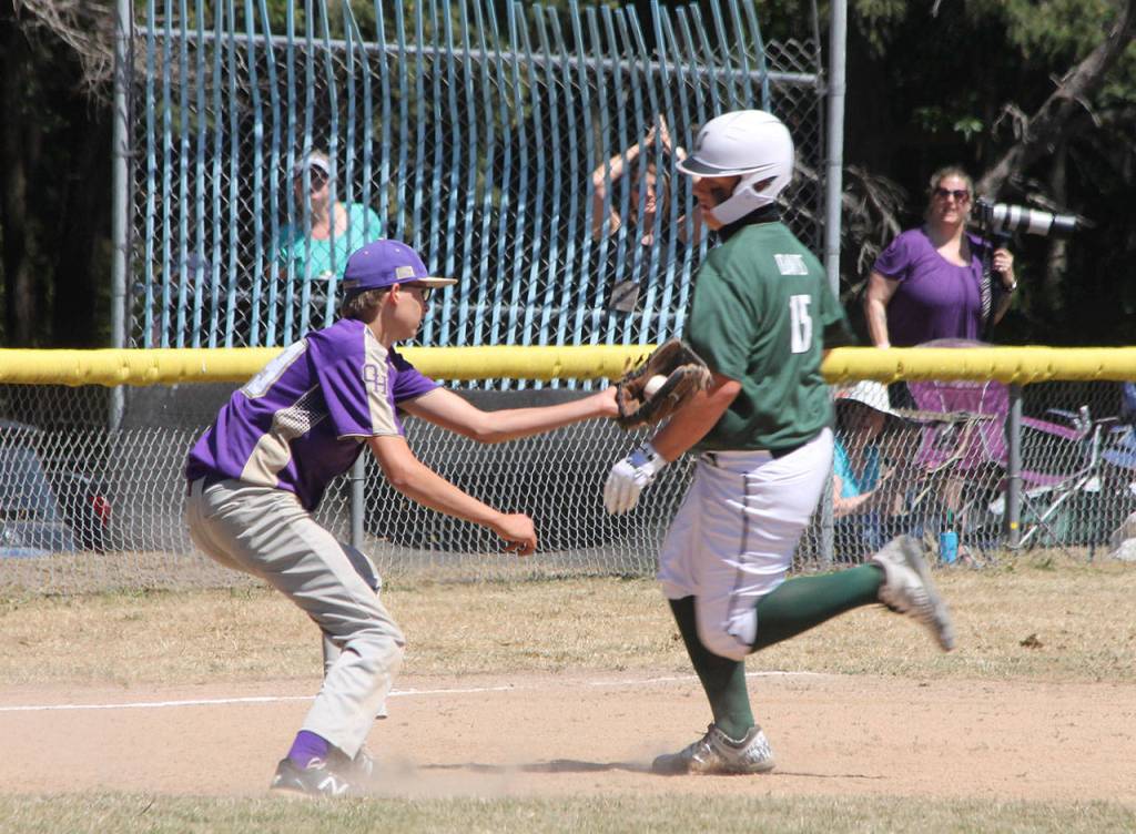 Oak Harbor third baseman Jackson Wesley attempts to tag a Stanwood runner Saturday. (Photo by Jim Waller/Whidbey News-Times)
