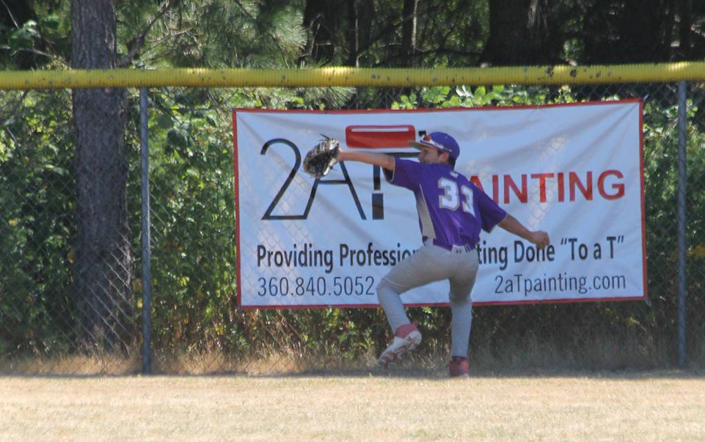 Centerfielder Jeroam Wood-Pina fires the ball back into the infield for Oak Harbor. (Photo by Jim Waller/Whidbey News-Times)