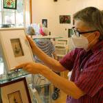 Photo by Kira Erickson/Whidbey News Group                                Madrone Moulton, who does mixed media art, sets out a shadow box on the gallerys shelf.