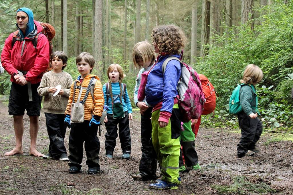 Photo provided                                Whidbey Island Waldorf School teacher William Dolde leads his kindergarten class on a trip into the woods in 2016. Dolde said he is used to teaching his classes outdoors, immersed in nature. Its a model the Waldorf School is adopting for all of its kindergarten classes this year.