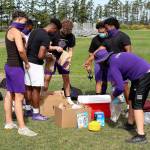 Oak Harbor athletes take advantage of the Whidbey AthlEATS program after a workout at Fort Nugent Park Wednesday. (Photo by John Fisken)