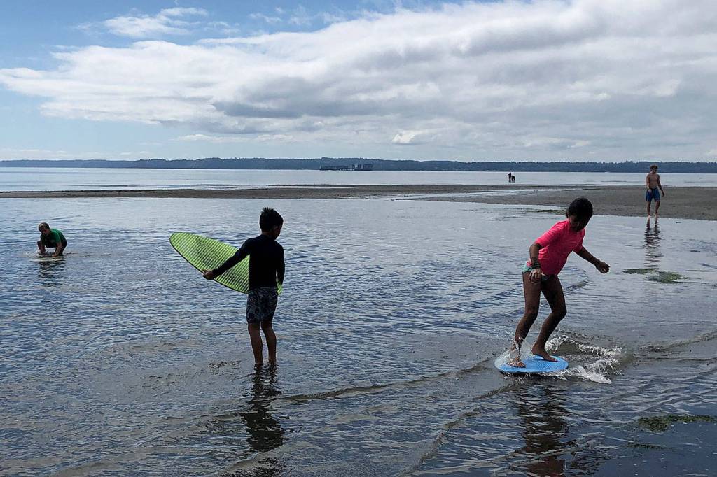 Students skimboard at Double Bluff.                                Photo by Emily Gilbert/Whidbey News-Times.