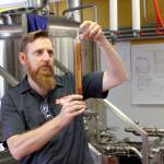 Photo by Jessie Stensland / Whidbey News Group
Assistant Brewer Erickson Adam eyeballs a sample in Penn Cove Brewerys new facility.