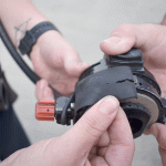 North Whidbey Fire and Rescue chief John Clark and Becky Azure points to a tear in a piece of a self-contained breathing apparatus.