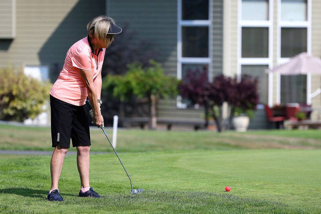 Celia Horton strokes a long putt in last weeks match. (Photo by John Fisken)