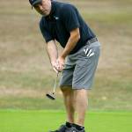 Marc Aparicio follows a putt as it heads to the hole in the Bennett Boyles Golf Tournament. Aparicio is one of the owners of the Penn Cove Brewing Company, which organized the event. (Photo by John Fisken)
