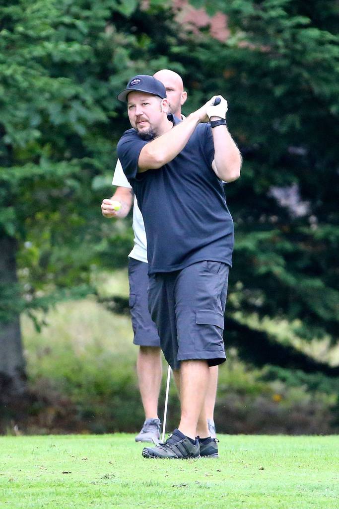 Tim Grove watches his shot head to the green. (Photo by John Fisken)