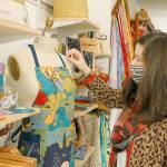 Owner Jennifer Robinson of the Blue Peony opened up her first storefront of fabric products in Langley in July. One of her favorite aprons she made, hunks gardening, is displayed in the store. Photo by Kira Erickson/Whidbey News-Times