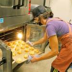 Baker Stefanie Stuchell lifts a tray of gougeres, cheese-filled pastries, from the oven. She is one of the five bakers for Salt Sea Provisions. Photo by Kira Erickson/Whidbey News-Times