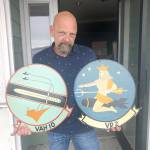 Photo by Emily Gilbert/Whidbey News-Times.Kenneth Peplinski bought both the builidng and the business of the Oak Harbor Tavern, which included all of the military memorabilia donated by patrons over the years, including these two squadron signs that are decades old. He had to leave the taverns old building because he fell behind on payments, but he hopes to reopen the business in a new location in downtown Oak Harbor.