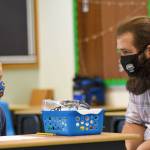 Paraeducator Brion Lanata speaks with student Keaka Mollitor. Photo by Conor Laffey / Oak Harbor Schools