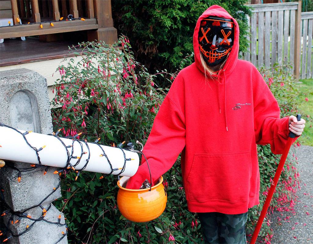 Photo by Kira Erickson/Whidbey News Group
Piper Pontius, 11, demonstrates how the candy chute outside her grandparents house will work.