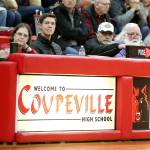 June Mazdra, left, and her husband Marty, third from left, have worked at the Coupeville High School basketball score table for 25 years. (Photo by John Fisken)
