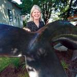 Georgia Gerber with her whale statue on display along First Street on Thursday, Aug. 13, 2020 in Langley, Wa. (Olivia Vanni / The Herald)