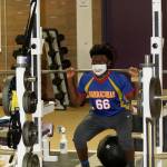 Michael Johnson-Howard lifts weights during a recent Oak Harbor High School football workout. (Photo by Jim Waller/Whidbey News-Times)