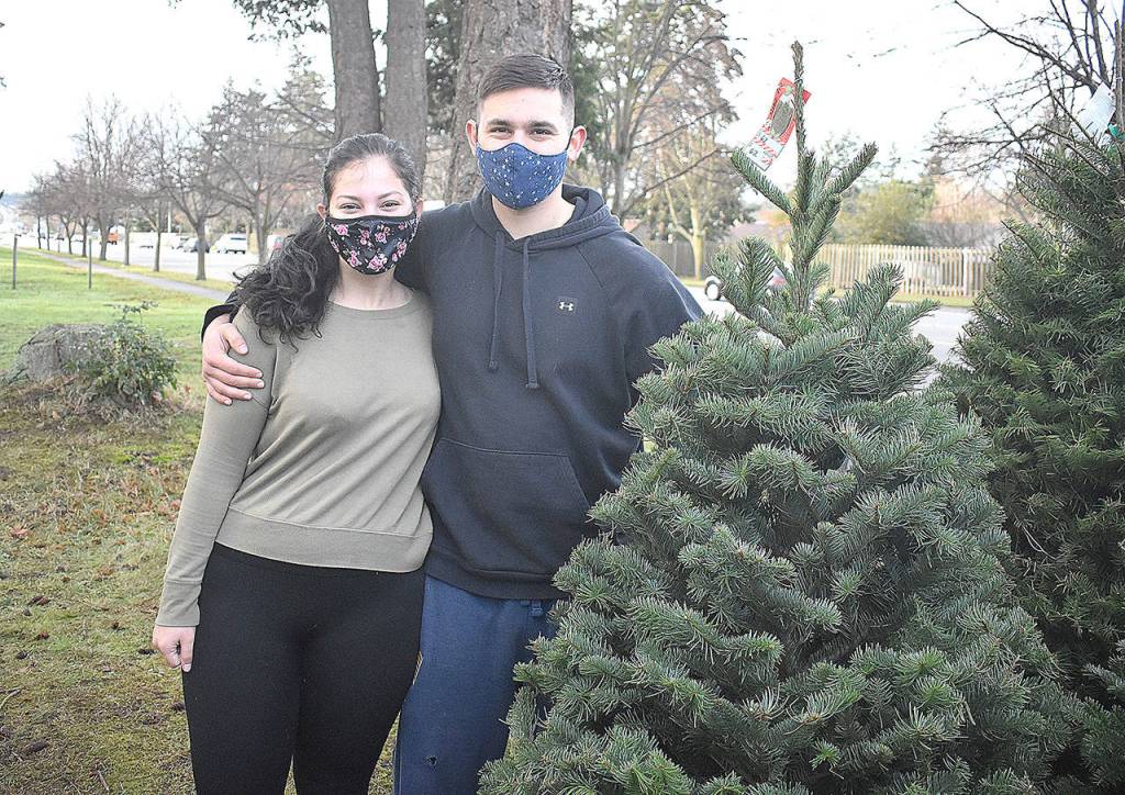 Alex Barron and Skylar Ponton found a Christmas tree at the Oak Harbor Lions Club annual sale next to the Chamber of Commerce building before the tannenbaums are gone. Photo by Emily Gilbert/Whidbey News-Times