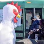 The Whidbey Island Chicken meets young fan, Aria Smith, and her dad, Josiah, on Saturday morning in Oak Harbor. Emily Gilbert/Whidbey News-Times