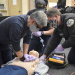 Firefighter Jeff Rhodes (left), Firefighter Keith Dawson (center, back), Acting Lieutenant Alex Majestic (right) practice a CPR response without the LUCAS 3 Chest Compression System the agency wants to buy. Photo by Emily Gilbert/Whidbey News-Times