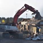Photo by Emily Gilbert/Whidbey News-Times An excavator demolishes the Oak Harbor McDonalds on Feb. 17. The madrona tree on the left side will be taken down to make way for the new building, although one woman tried to save it.