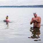 Joe Hempel (right), and Kristin Galbreaith finish their 35-minute, one-mile swim from Seawall Park in Langley. (Olivia Vanni / The Herald)
