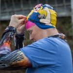 Kristin Galbreaith puts on a Rosie the Riveter swim cap before her swim. (Olivia Vanni / The Herald)