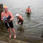 Photos by Olivia Vanni/The Everett Herald
Kristin Galbreaith, left, Joe Hempel and Brian McCleary make their way out of the water at Seawall Park in Langley. Photo below: Joe Hempel, right, and Kristina Galbreaith finish their swim from Seawall Park on Friday, Jan. 29,
